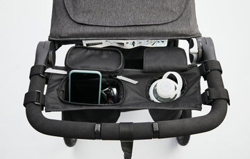 Overhead view of opened parent organizer with bottle, phone, and keys
